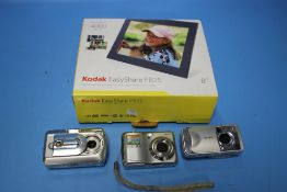 A BOXED KODAK EASYSHARE P825 ALONG WITH THREE DIGITAL CAMERAS