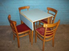 A RETRO DROP LEAF FORMICA KITCHEN TABLE AND FOUR POLISH CHAIRS