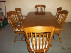 A MODERN EXTENDING WOODEN DINING SET WITH SIX CARVER CHAIRS