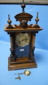 AN ANTIQUE WALNUT CASED MANTEL CLOCK