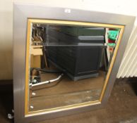 A MODERN FRAMED MIRROR 99 X 94 CM