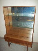 A RETRO TEAK SMALL DISPLAY MIRROR BACKED UNIT WITH GLASS SHELVES AND SLIDING GLASS DOORS MADE BY