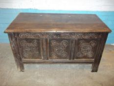 AN ANTIQUE OAK BLANKET CHEST COFFER WITH CARVED DETAIL