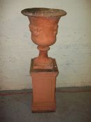 A TERRACOTTA TYPE CONCRETE GARDEN PLANTER / URN AND PEDESTAL