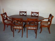 AN EXTENDING INLAID DINING SET TABLE AND SIX CHAIRS TO INCLUDE TWO CARVERS