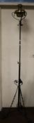 A VINTAGE TALL CAST AND BRASS OIL LAMP ON TRIPOD BASE