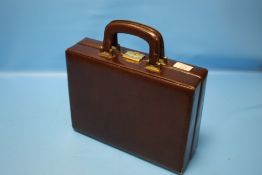 A LEATHER ATTACHE CASE