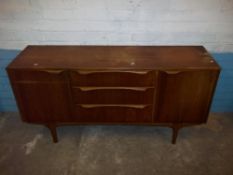 A RETRO TEAK SIDEBOARD IN NEED OF COSMETIC RESTORATION