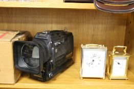 TWO CARRIAGE CLOCKS AND A NOVELTY CAMERA RADIO