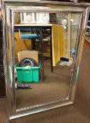 A SILVER COLOURED FRAMED MIRROR TOGETHER WITH A WOODEN FRAMED MIRROR