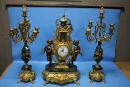 A REPRODUCTION FRENCH STYLE CLOCK GARNITURE IN GILT METAL AND GREEN MARBLE