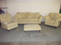 A RETRO STYLED FABRIC FOUR PIECE SUITE WITH FOOTSTOOL AND THREE SEATER SOFA