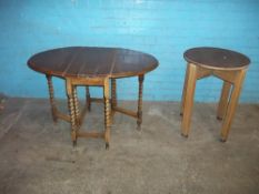 TWO ANTIQUE TABLES COMPRISING A BARLEY TWIST OAK DROP LEAF TABLE AND AN OAK CIRCULAR PUB TYPE TABLE