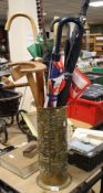 A BRASS STICK STAND ALONG WITH SIX UMBRELLAS AND TWO WALKING STICKS AND A SET SQUARE