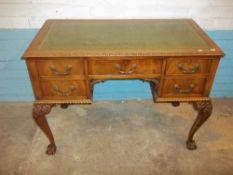 A DECORATIVE LEATHER INLAID DESK WITH CABRIOLE CLAW AND BALL LEGS