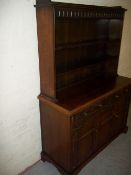 AN OAK DRESSER WITH CARVED DETAILING