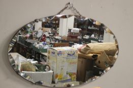AN OVAL MIRROR, 61 X 35.5 CM