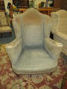 A VINTAGE WING-BACK ARMCHAIR WITH HAIRY PAW FEET A/F