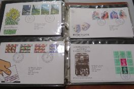 AN ALBUM OF POST OFFICE FIRST DAY COVERS, TOGETHER WITH THREE COMMEMORATIVE COINS AND STAMPS FIRST