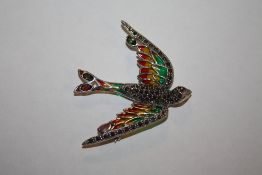 A PLIQUE-A-JOUR BROOCH IN THE FORM OF A BIRD IN FLIGHT