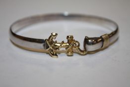 A WHITE AND YELLOW METAL BANGLE STAMPED STERLING 14K WITH ANCHOR SHAPED CLASP APPROX WEIGHT - 15.3G