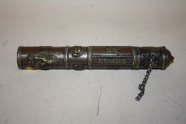 AN ORIENTAL COPPER AND BRASS SCROLL HOLDER