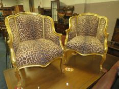 A PAIR OF GILT FRAMED LOUIS XV ARMCHAIRS IN A CONTEMPORARY LEOPARD UPHOLSTERY