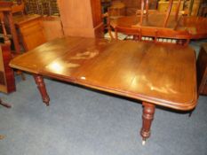 A VICTORIAN MAHOGANY WIND-OUT DINING TABLE WITH TWO EXTRA LEAVES, RAISED ON TURNED SUPPORTS -