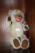 A VINTAGE JOINTED TEDDY BEAR WITH GLASS EYES AND PULL STRING
