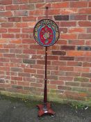 AN ANTIQUE MAHOGANY POLE SCREEN WITH CIRCULAR BEADWORK PANEL
