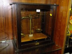 A SET OF MAHOGANY AND GLASS CASED SCALES BY L. BECKER OF FRANCE