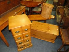A HONEY PINE BLANKET BOX, SET OF DRAWERS, WICKER BASKET AND COFFEE TABLE (4)