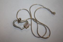 A SILVER HEART PENDANT ON CHAIN