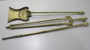 A VINTAGE BRASS THREE PIECE FIRESIDE COMPANION SET
