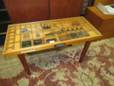 A PRINTERS DISPLAY TABLE, MODELLED WITH A TRAY TOP AND ASSORTED SAMPLES, TOOLS ETC H-46 W-82 CM