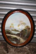 AN OVAL FRAMED AND GLAZED OIL ON BOARD DEPICTING A COUNTRY PATH - SIZE 51CM X 40CM