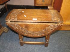 A SMALL CARVED OAK DROPLEAF TABLE