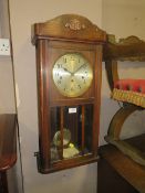 A VINTAGE OAK CASED WALLCLOCK