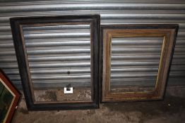 TWO GILT AND EBONISED WOODEN PICTURE FRAMES - LARGEST REBATE SIZE 65.5CM X 49CM - SMALLEST REBATE