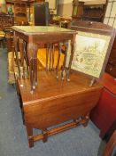 A HEAVY OAK DROPLEAF TABLE WITH AN OAK FRAMED FIRESCREEN AND A GLASS TOPED NEST OF TABLES (3)
