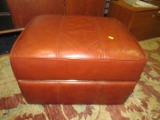 A MODERN TAN LEATHER FOOTSTOOL