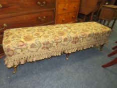 AN ANTIQUE MAHOGANY FRAMED LONG LOW STOOL ON CASTORS H-38 L-140 CM