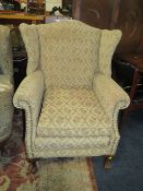 A VINTAGE WING - BACK ARMCHAIR WITH BALL AND CLAW FEET - A/F