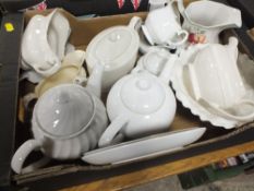 A TRAY OF MOSTLY PLAIN WHITE TEAPOTS TOGETHER WITH A TRAY OF GLASSWARE AND A SMALL TRAY OF METALWARE