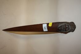 A BLACK FOREST STYLE CARVER WOODEN PAGE TURNER IN THE FORM OF A GENTLEMAN