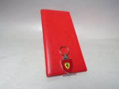 A FERRARI SALES NETWORK CONVENTION RED LEATHER WALLET, Maranelo, February 2005, approx 23 x 11.5 cm,