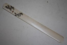 A JAPANESE MEIJI PERIOD IVORY PAGE TURNER WITH SILVER SCROLLING DETAIL, the silver formed as a