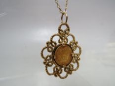 A 1945 DOS PESOS GOLD COIN PENDANT ON CHAIN, the gold coin mounted in a 9ct gold pendant suspended