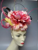 A HANDCRAFTED FASCINATOR BY K J MILLINERY, large central flower with matched ribbon style