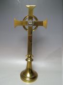 A BRASS CHURCH ALTAR CRUCIFIX, of classic geometric form, raised on circular base, with white